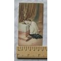 Vintage illustrated card - saint kneeling at altar