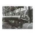 Q 30134: A female munitions worker is lifted in...