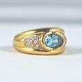 Massive solid gold ring with blue bezel set top...
